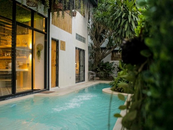 Modern tropical villa with private pool and lush greenery — contemporary real estate investment style